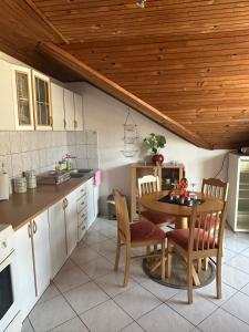 a kitchen with a table and chairs in a room at Đenovici Apartmans in Đenovići