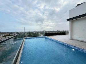 a swimming pool on the roof of a building at Swiss Lodge, Labone in Accra