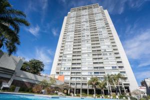 a tall white building with a pool in front of it at San Telmo Spa in Buenos Aires