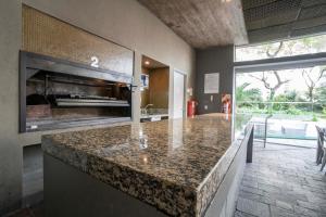 a kitchen with a counter top with a fireplace at San Telmo Spa in Buenos Aires