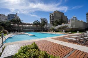 a swimming pool in a city with buildings at San Telmo Spa in Buenos Aires