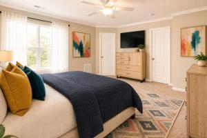 a bedroom with a bed and a dresser with a tv at Jackson Pines Getaway in Jackson