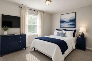 a bedroom with a large bed and a television at Jackson Pines Getaway in Jackson