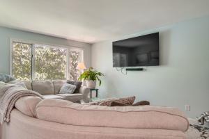 a living room with a couch and a flat screen tv at Riverside Extended Stay in Mashpee in Mashpee