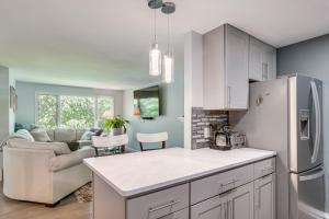 a kitchen and living room with a couch and a refrigerator at Riverside Extended Stay in Mashpee in Mashpee