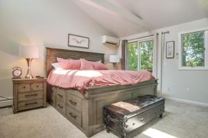 a bedroom with a large bed with pink sheets at Riverside Extended Stay in Mashpee in Mashpee
