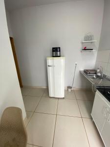 a small white refrigerator in a small kitchen at Aconchegante é silencioso in Rio Verde +16 photos