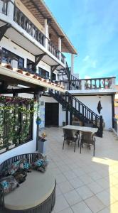 a patio with a table and stairs on a building at Pousada Mar Dos Anjos in Arraial do Cabo