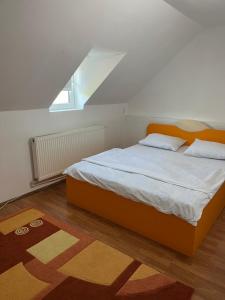 a bedroom with a bed with an orange headboard at Cabana Vladimir in Cucuceni +43 photos