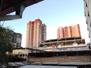 a group of tall buildings in a city at Colman Apart Central 07 in Ciudad del Este