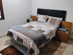 a bedroom with a large bed with a wooden headboard at Colman Apart Central 07 in Ciudad del Este