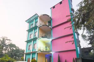 a building painted in different colors at Hotel O Aagman Guest House in Hākala