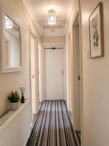 a hallway with a white door and a hallway sidx sidx sidx at Amethyst Loft Room in Farnham Royal
