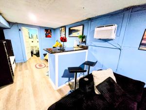 a blue trailer with a kitchen and two stools at 2 BEDROOM APARTMENT 20 min-Newark Airport 15 min- Stadium Downtown Newark- Branch Brook park inn in Newark