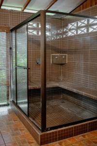 a large glass enclosure in a room with aificialificialificialificialificialificialificial at Cabinas Jenny Cahuita in Cahuita