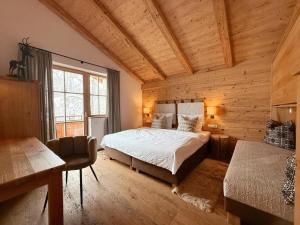 a bedroom with a bed in a wooden room at Wildrose in Wagrain
