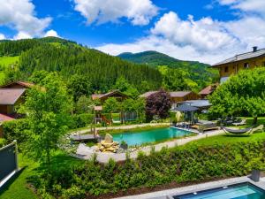 an estate with a swimming pool and a mountain at Wildrose in Wagrain