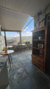 a room with a view of a patio with tables and chairs at Pousada Mineira in Ouro Preto