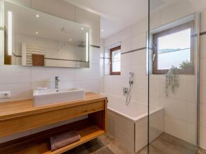 a bathroom with a sink and a shower and a tub at Tauernpanorama in Krimml +34 photos