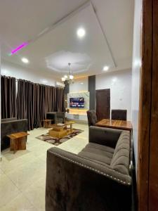 a living room with a couch and a table at Elected Apartments in Iseri-Oke