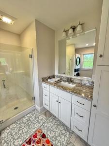 a bathroom with two sinks and a shower at The Happy Hive in Bridgton +39 photos