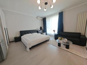 a bedroom with a bed and a couch and a table at Times International in Beijing