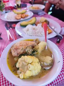 a plate of food with meat and vegetables on a table at Cabaña Colibrí Silvania Cundinamarca in Silvania