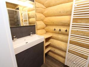 a bathroom with a white sink and a wooden wall at Jenig 5A in Jenig +42 photos