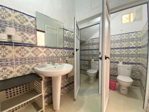 a bathroom with a sink and two toilets at Red Carpet Surf Camp Tamraght , Sea & Mountain View, Surf Lessons Available in Tamraght Ouzdar