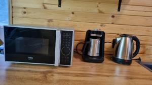 a microwave and a coffee maker on a counter at Keda Horizon cottage in K'eda +2 photos