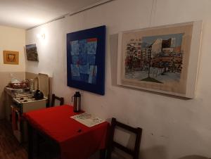 a dining room with a red table and a kitchen at Artistic Mini Loft & Sun Terrace in La Paz