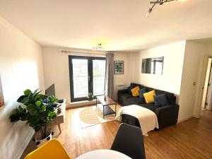 a living room with a couch and a table at VIPAbodes at Woking Central in Woking