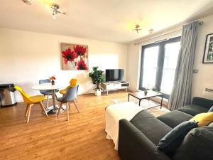 a living room with a couch and a table at VIPAbodes at Woking Central in Woking