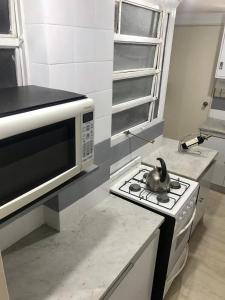 a kitchen with a microwave and a stove top oven at Palermo facing Las Heras Park in Buenos Aires