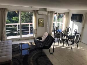 a living room with a table and chairs and a couch at Palermo facing Las Heras Park in Buenos Aires