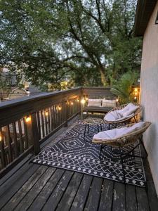 a patio with two chairs and a table on a deck at Luxe Chicago Retreat Game Room, Deck Fire Pit in Chicago