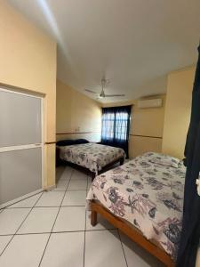 a room with two beds and a window at Las Brisas House, Manzanillo in Manzanillo +4 photos