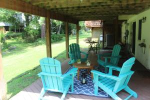 a group of blue chairs sitting on a porch at Lakeview - Tranquille private suite in Burke