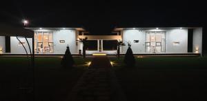 a large white house at night with lights at Gangneung Thebrillant in Gangneung