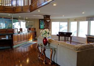 a living room with a couch and a piano at North Cliff Hotel in Fort Bragg