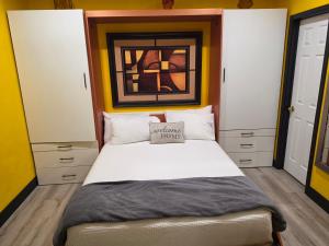a bedroom with a bed with a picture on the wall at Houston Sweet Spot Townhouse in Houston