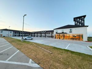 a parking lot with a car parked in front of a building at Clarion Pointe Port Lavaca in Port Lavaca