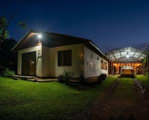 a car parked next to a house at night at Hills Villa Rio Celeste in Rio Celeste
