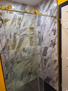a shower with a glass door in a bathroom at Houston Sweet Spot Townhouse in Houston +25 photos