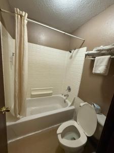 a bathroom with a tub and a toilet and a bath tub at America's Best Inn & Suites Eureka in Eureka