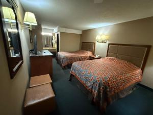a hotel room with two beds and a television at America's Best Inn & Suites Eureka in Eureka