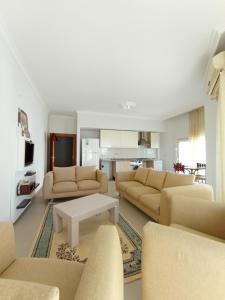 a living room with couches and a coffee table at Antalya Premium Resort in Antalya