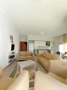 a living room with two couches and a table at Antalya Premium Resort in Antalya