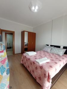 a bedroom with a large bed with a pink blanket at Antalya Premium Resort in Antalya +93 photos