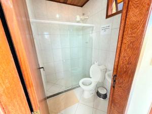 a small bathroom with a toilet and a shower at Pousada Azul do Mar by BlueOcean in Arraial do Cabo +59 photos